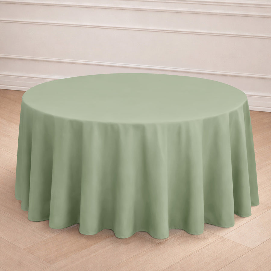 Round green tablecloth draped elegantly on a table in a styled setting.