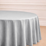 Round silver tablecloth draping elegantly over a table.
