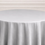 Round table covered with a smooth gray tablecloth.