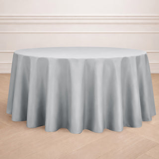 Round gray tablecloth draped elegantly over a circular table.