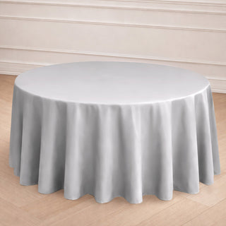 Round gray tablecloth draping elegantly over a circular table.