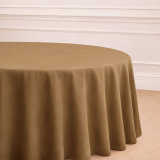 Brown tablecloth draped over a round table in a styled interior setting.