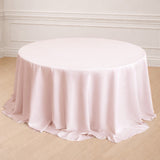 Round pink tablecloth elegantly draping over a round table.