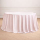 Round pink tablecloth draped elegantly over a table.