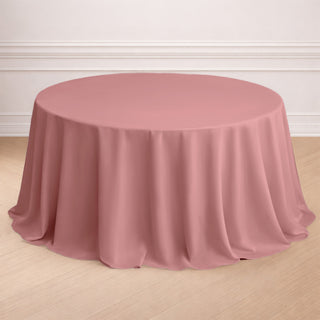 Round pink tablecloth draped elegantly over a table.