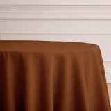 Brown round tablecloth on a table in a minimalist setting.