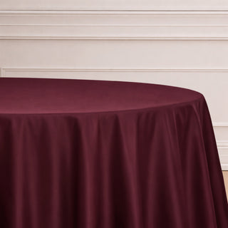 Burgundy tablecloth draped elegantly over a round table.