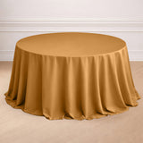 Round table with a gold tablecloth draped elegantly.