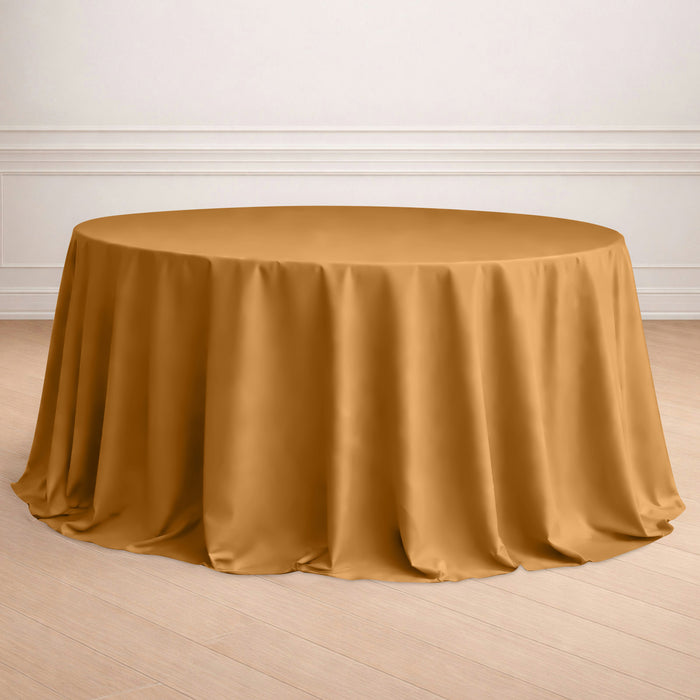 Round mustard tablecloth draped elegantly over a table in a styled setting.