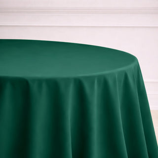 Green round tablecloth on a plain surface.
