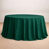 Green round tablecloth draped elegantly over a table in a staged setting.