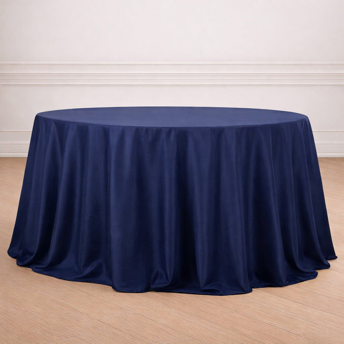Navy blue round tablecloth draped elegantly on a wooden floor.