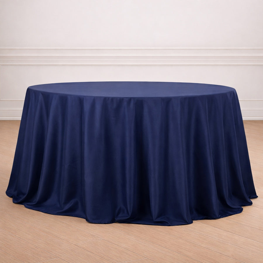 Navy blue round tablecloth draped elegantly on a wooden floor.