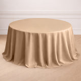 Beige round tablecloth on a wooden floor.