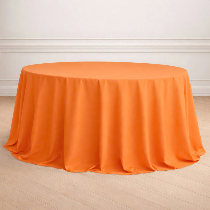 Round orange tablecloth draped elegantly on a table.