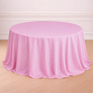Round pink tablecloth draped elegantly over a table.