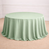 Round mint green tablecloth draped elegantly over a circular table.