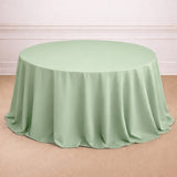 Round mint green tablecloth with elegant draping.