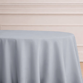 Gray tablecloth draped over a round table in an elegant setting.