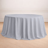 Round gray tablecloth on a wooden floor in an elegant setting.
