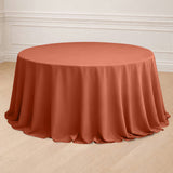 Round terracotta tablecloth draping elegantly over a circular table.