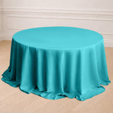 Turquoise round tablecloth draped elegantly over a table.