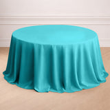 Turquoise round tablecloth draped on a circular table.