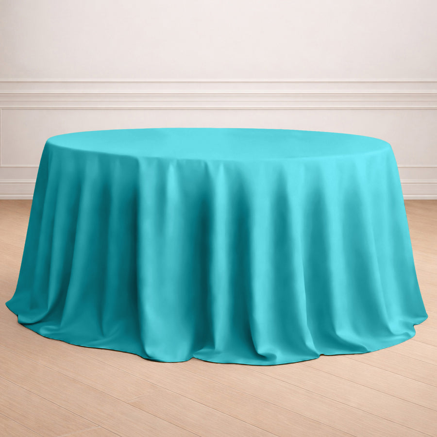 Turquoise round tablecloth draped elegantly over a table.