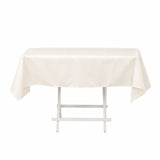 White rectangular tablecloth on a folding table against a white background