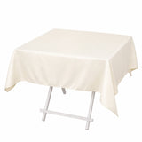 Cream rectangular tablecloth draped over a folding table with white legs