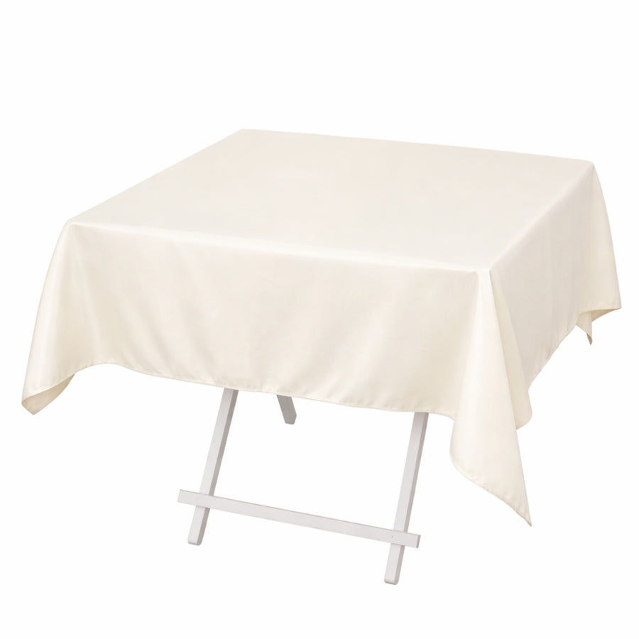 Cream rectangular tablecloth draped over a folding table with white legs