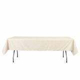 Beige rectangular tablecloth on a folding table with white background