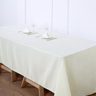 Add a Touch of Sophistication with the 60"x126" Ivory Seamless Polyester Rectangular Tablecloth