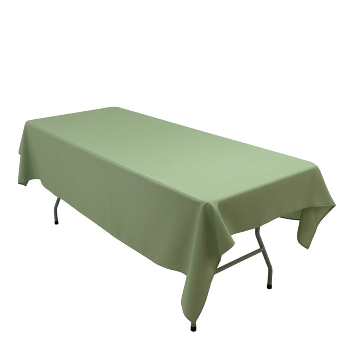Green tablecloth draped over a folding table on a plain backdrop.