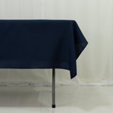 Navy blue tablecloth draping over a table leg