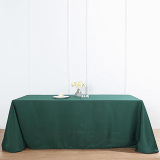 Add Elegance to Your Event with the 90"x132" Hunter Emerald Green Seamless Polyester Rectangular Tablecloth