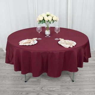 Elevate Your Event Decor with the 90" Burgundy Seamless Premium Polyester Round Tablecloth