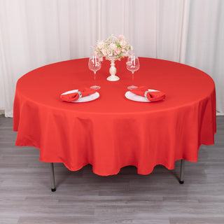Add Elegance to Your Event with the 90" Red Seamless Premium Polyester Round Tablecloth