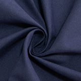 Navy tablecloth with a white plate and cutlery on a dining table. #whtbkgd