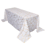 White tablecloth with gold geometric pattern, elegantly draped over a table.