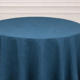 Blue tablecloth on a round table with a textured finish.