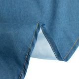 Denim fabric close-up showing texture and stitching detail.