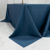 Dark blue tablecloth draping elegantly over a white marble surface.