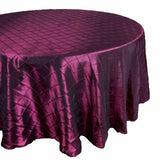 Round burgundy tablecloth with a quilted design on a white background. #whtbkgd