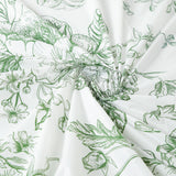 Floral patterned fabric with green illustrations on a white background.