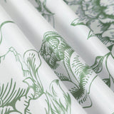 Green floral pattern fabric with soft texture and folds.