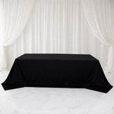 Black tablecloth draped elegantly over a table in a studio setting.
