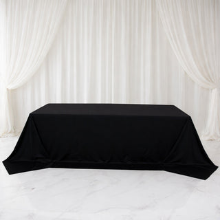 Black tablecloth draped elegantly over a table in a studio setting.