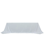 White table with draped fabric on a plain background.