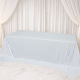 Light blue tablecloth draped over a table in a soft, elegant setting.
